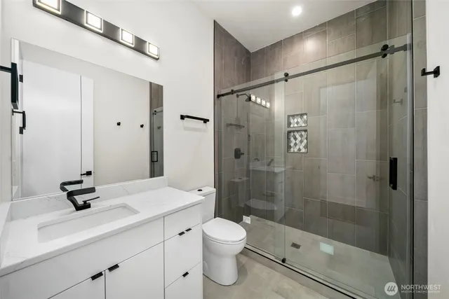 a bathroom with a shower sink a toilet and shower