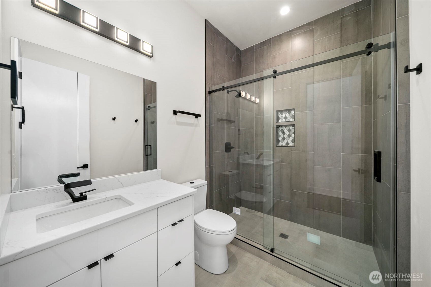 83 Summerset Boulevard Manson, WA 98831 - Photo 27 of 40 a bathroom with a shower sink a toilet and shower