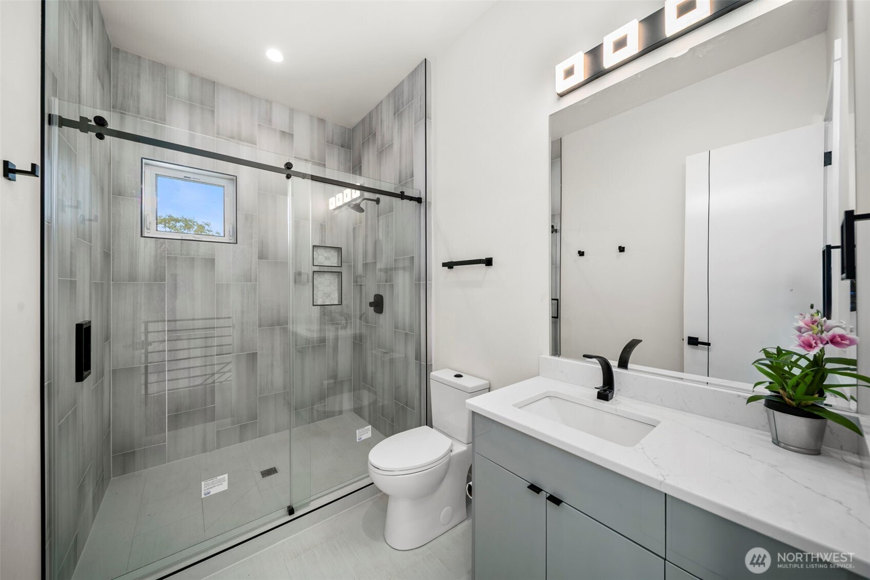 83 Summerset Boulevard Manson, WA 98831 - Photo 28 of 40 a bathroom with a shower sink vanity mirror and toilet