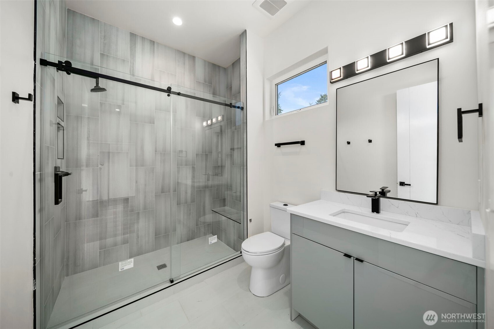 83 Summerset Boulevard Manson, WA 98831 - Photo 31 of 40 a bathroom with a shower sink vanity mirror and toilet