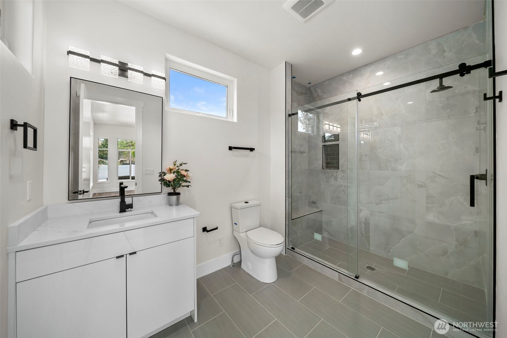 83 Summerset Boulevard Manson, WA 98831 - Photo 33 of 40 a bathroom with a shower sink vanity mirror and toilet