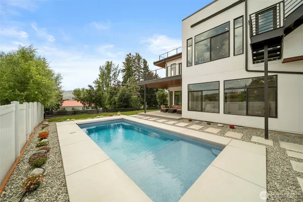 a view of a house with swimming pool and sitting area