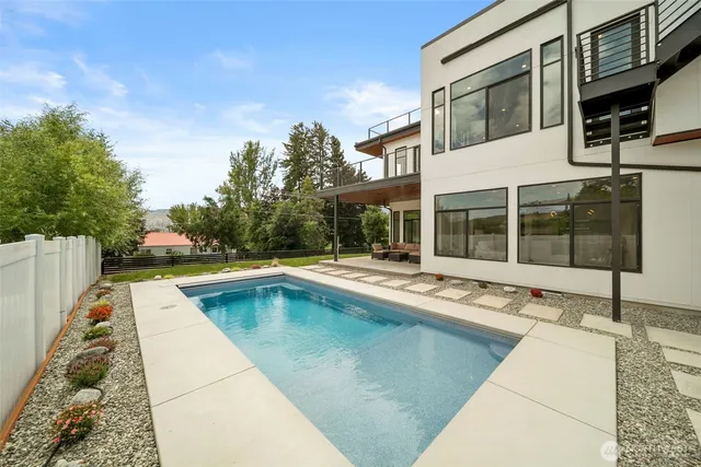 a view of a house with swimming pool and sitting area