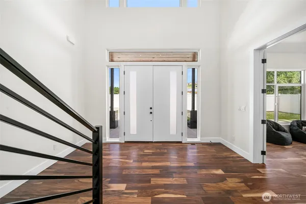 a view of a livingroom with wooden floor and stairs