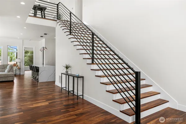 a view of entryway and hall with wooden floor