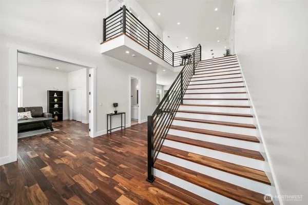 a view of entryway and hall with wooden floor