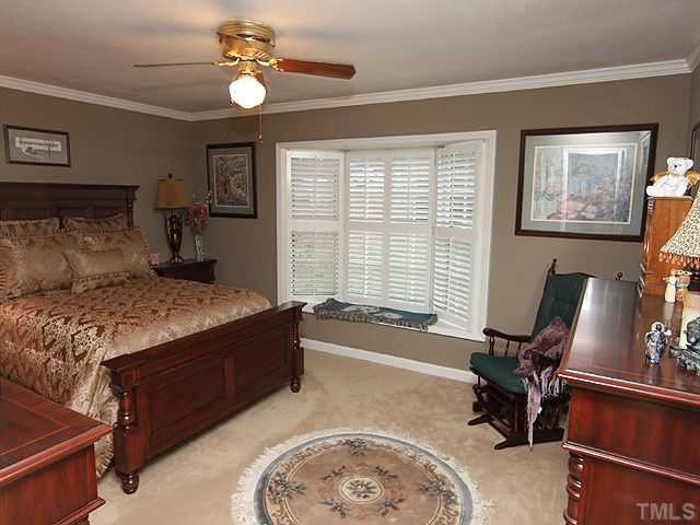 7819 Harps Mill Road Raleigh, NC 27615 - Photo 8 of 21 1st floor master retreat! The spacious master bedroom features a cozy bay window with plantation shutters. Master Suite