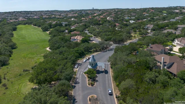an aerial view of a house with a yard
