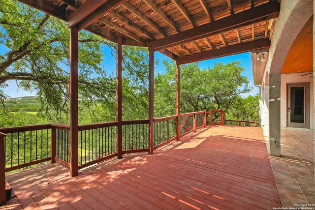 a porch with wooden floor in front of a house
