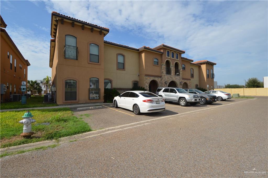 2705 Mimosa Street, Unit 2 Mission, TX 78574 - Photo 2 of 27 View of front facade featuring uncovered parking, stucco siding, and a tile roof