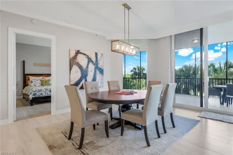 a view of a dining room and a table chairs