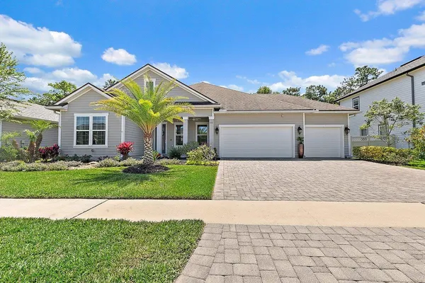 a view of a house with a yard and plants