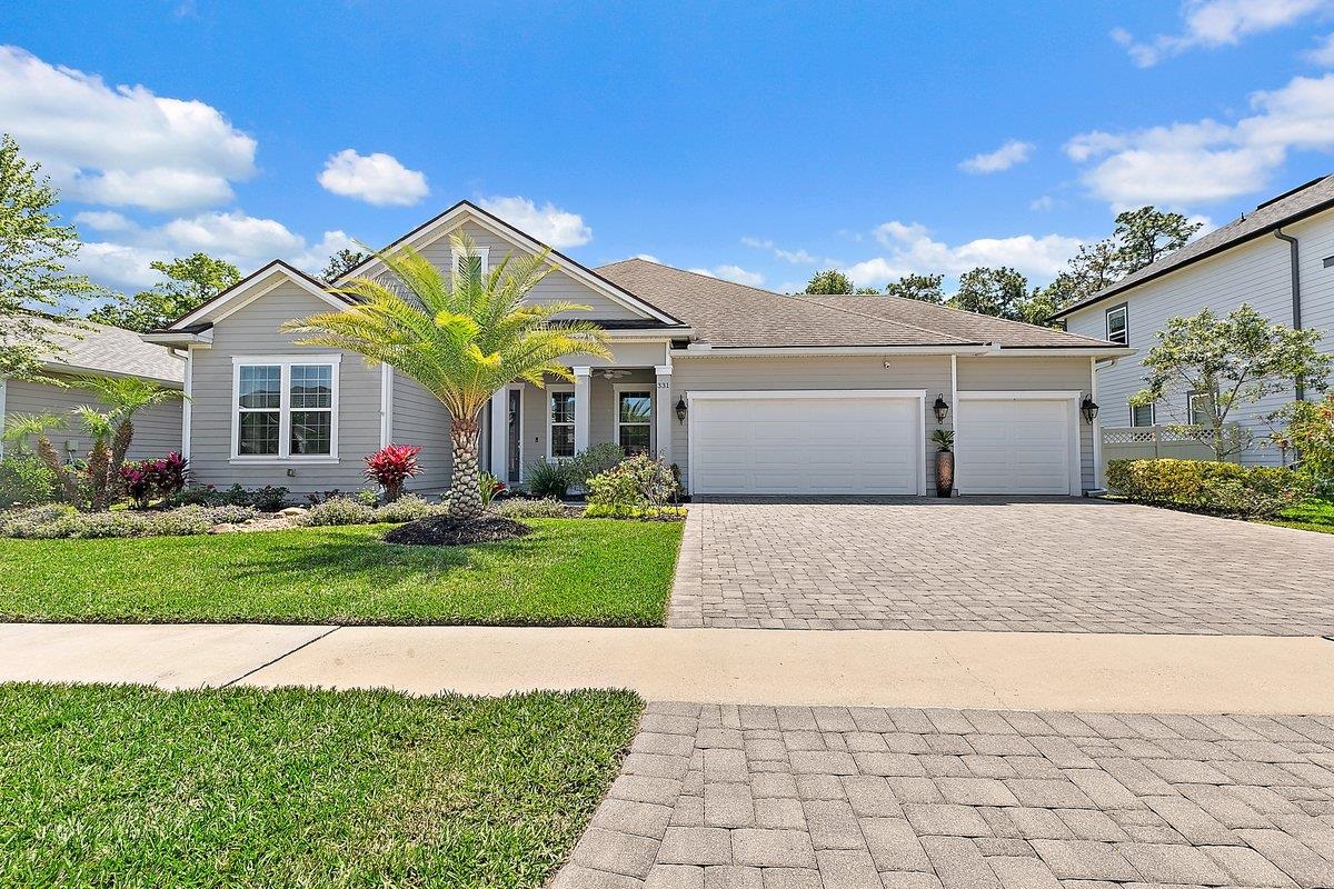 a view of a house with a yard and plants