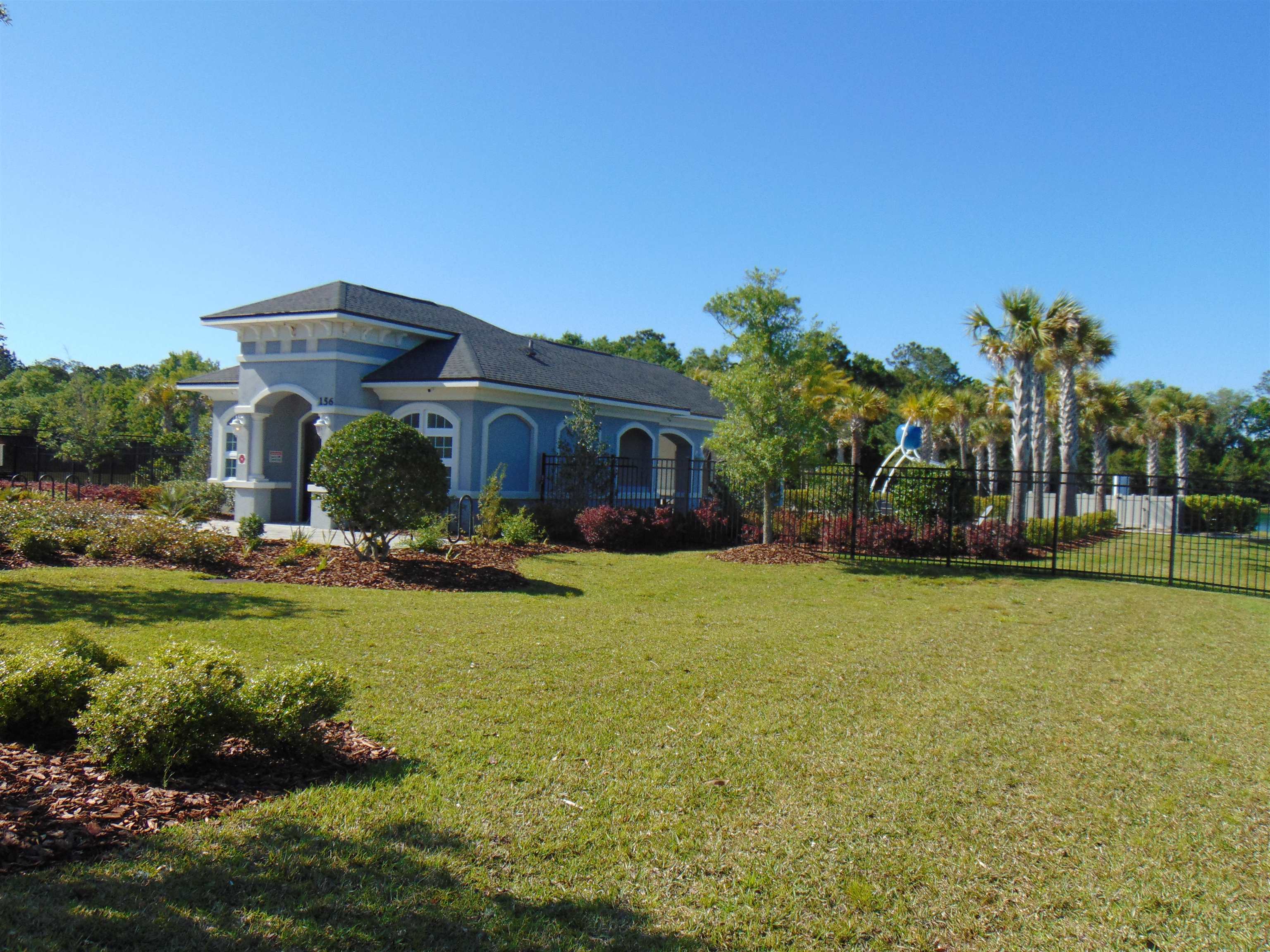331 Athens Drive St. Augustine, FL 32092 - Photo 23 of 24 a front view of a house with a garden and patio
