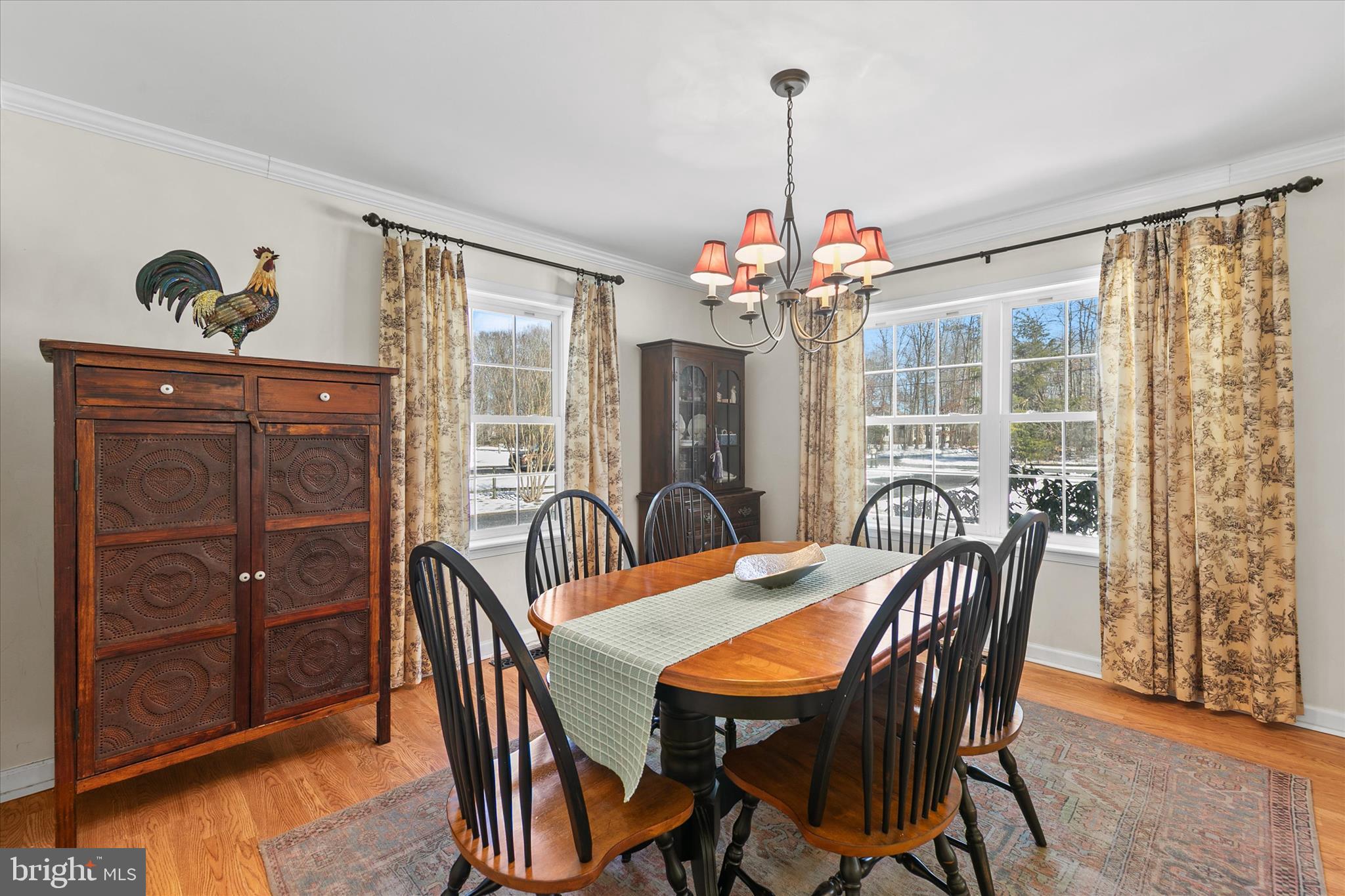 24618 Peterkins Road Georgetown, DE 19947 - Photo 14 of 47 a dining room with furniture a chandelier and wooden floor