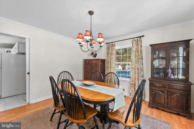 a dining room with furniture and wooden floor