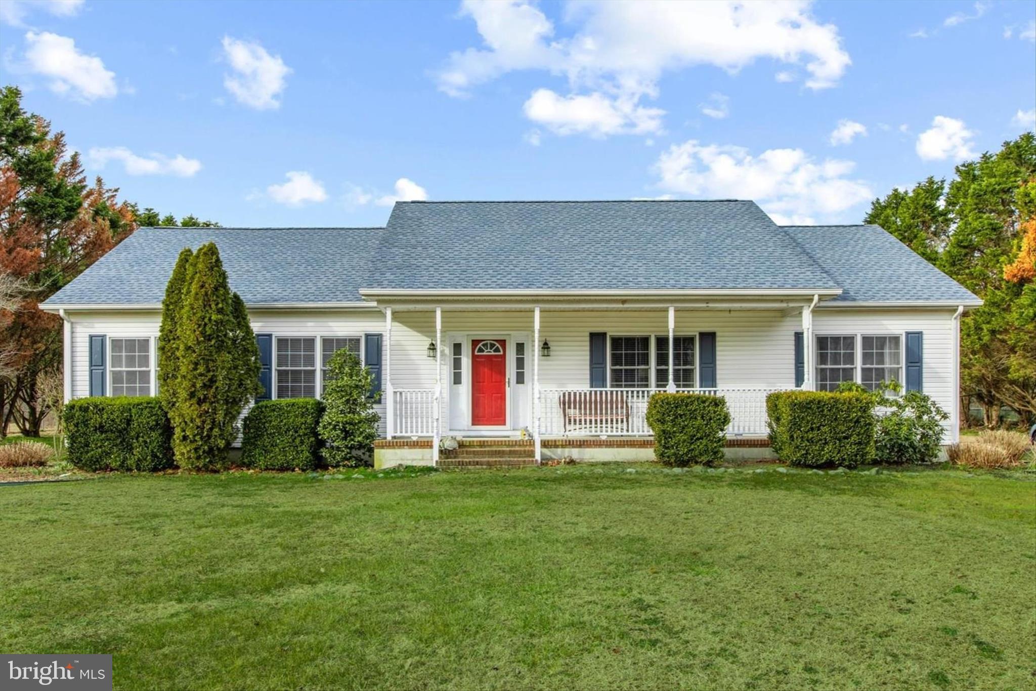24618 Peterkins Road Georgetown, DE 19947 - Photo 2 of 47 a front view of a house with a yard and porch