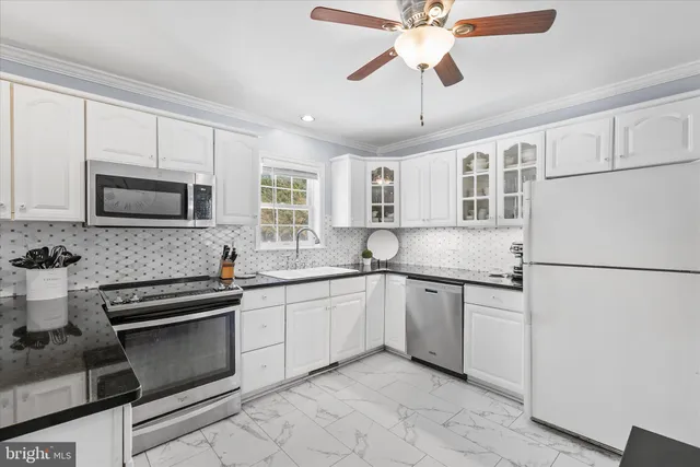 a kitchen with sink cabinets and window