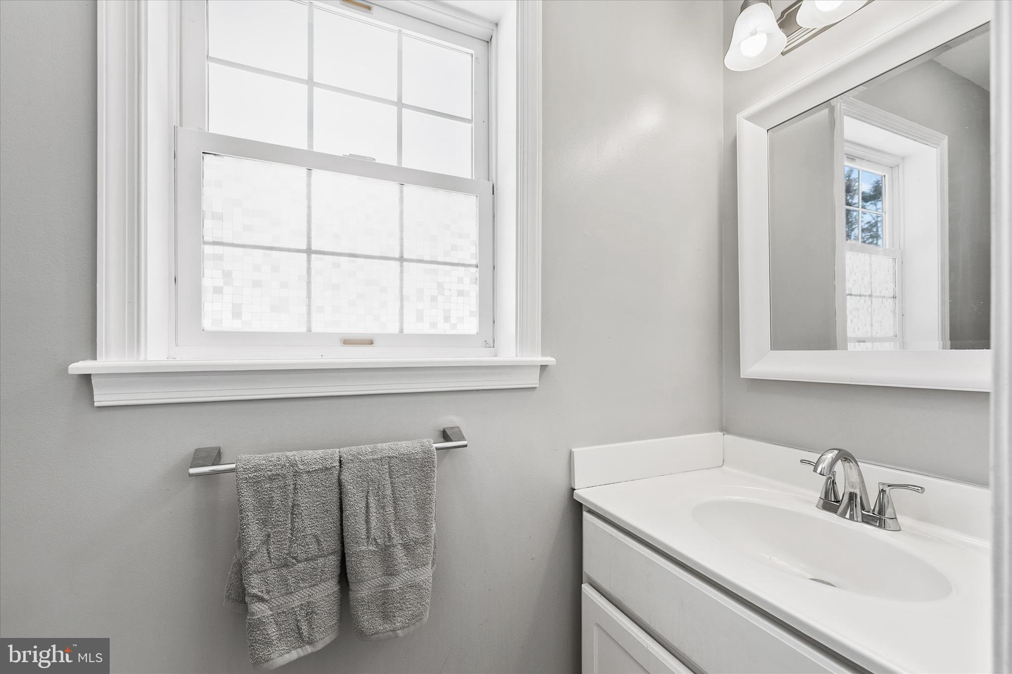 24618 Peterkins Road Georgetown, DE 19947 - Photo 27 of 47 a bathroom with a sink and a window