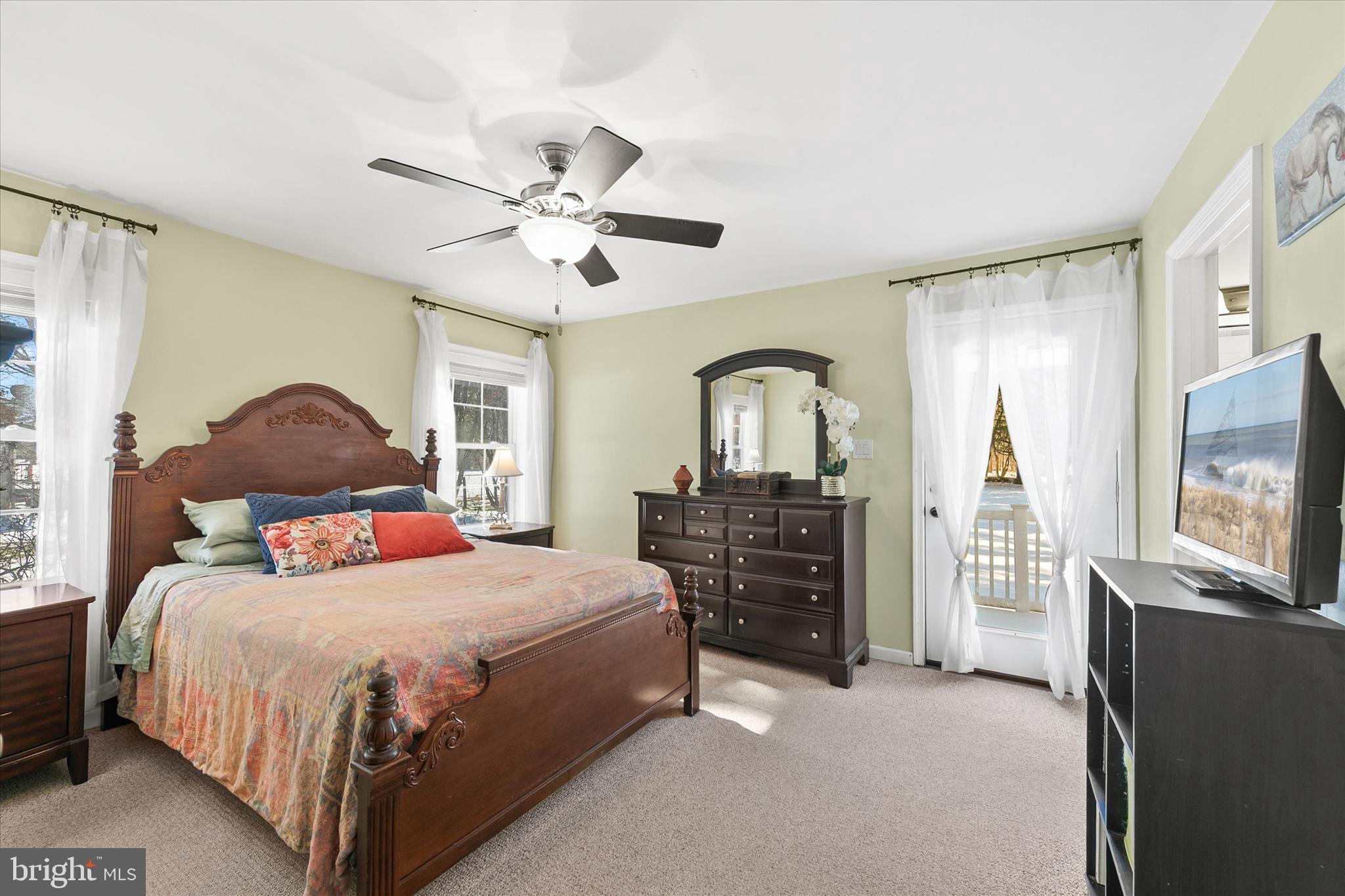 24618 Peterkins Road Georgetown, DE 19947 - Photo 28 of 47 a bedroom with a bed and a chandelier
