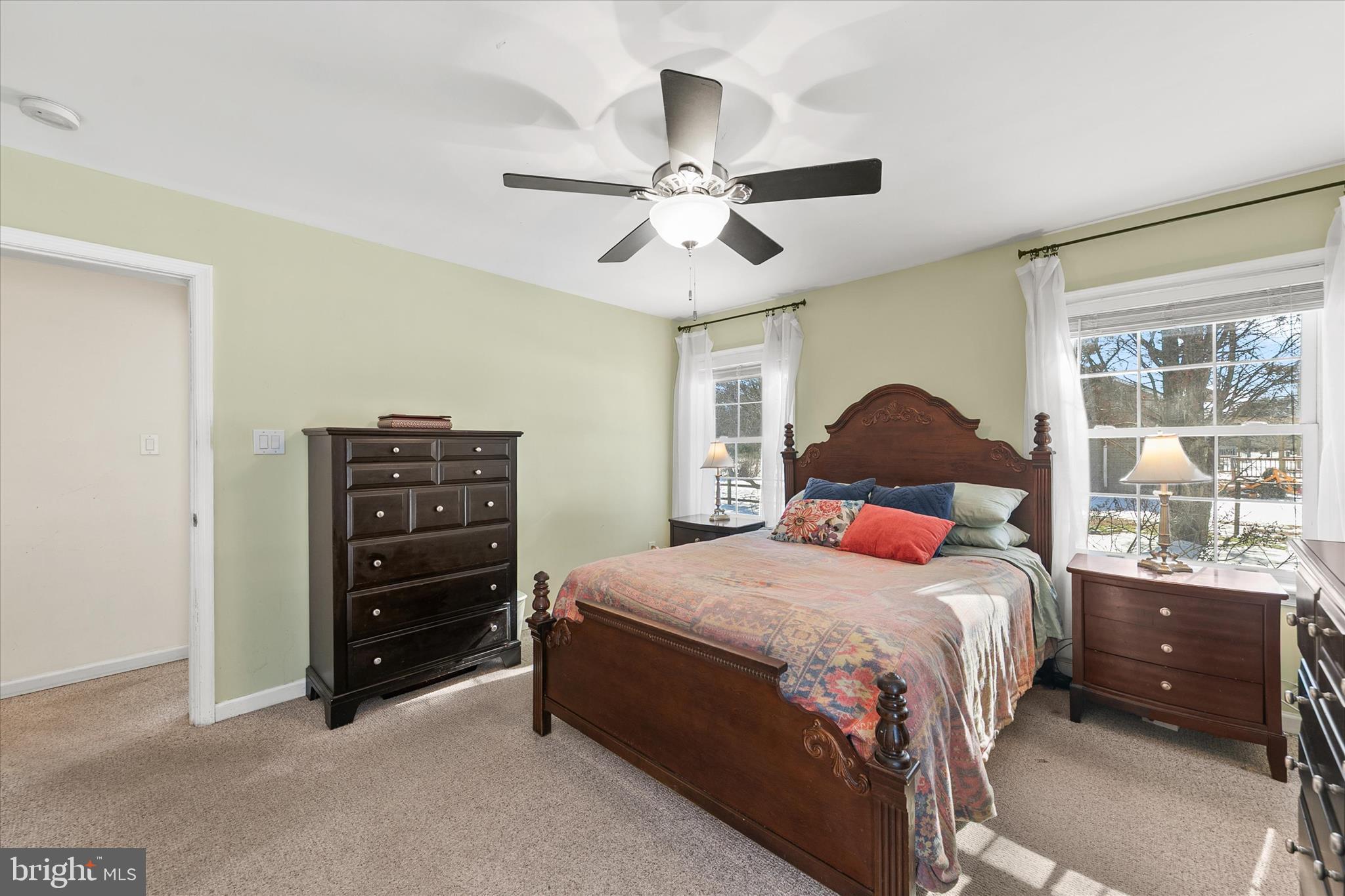 24618 Peterkins Road Georgetown, DE 19947 - Photo 31 of 47 a bedroom with a bed and a chandelier