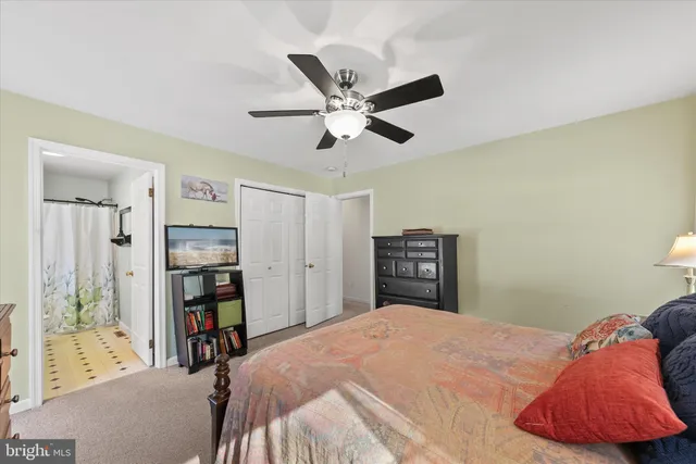 a bathroom with a granite countertop sink a toilet and mirror