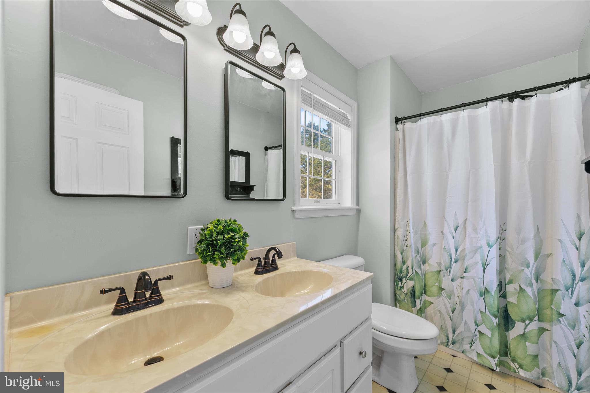 24618 Peterkins Road Georgetown, DE 19947 - Photo 33 of 47 a bathroom with a granite countertop sink a toilet and mirror