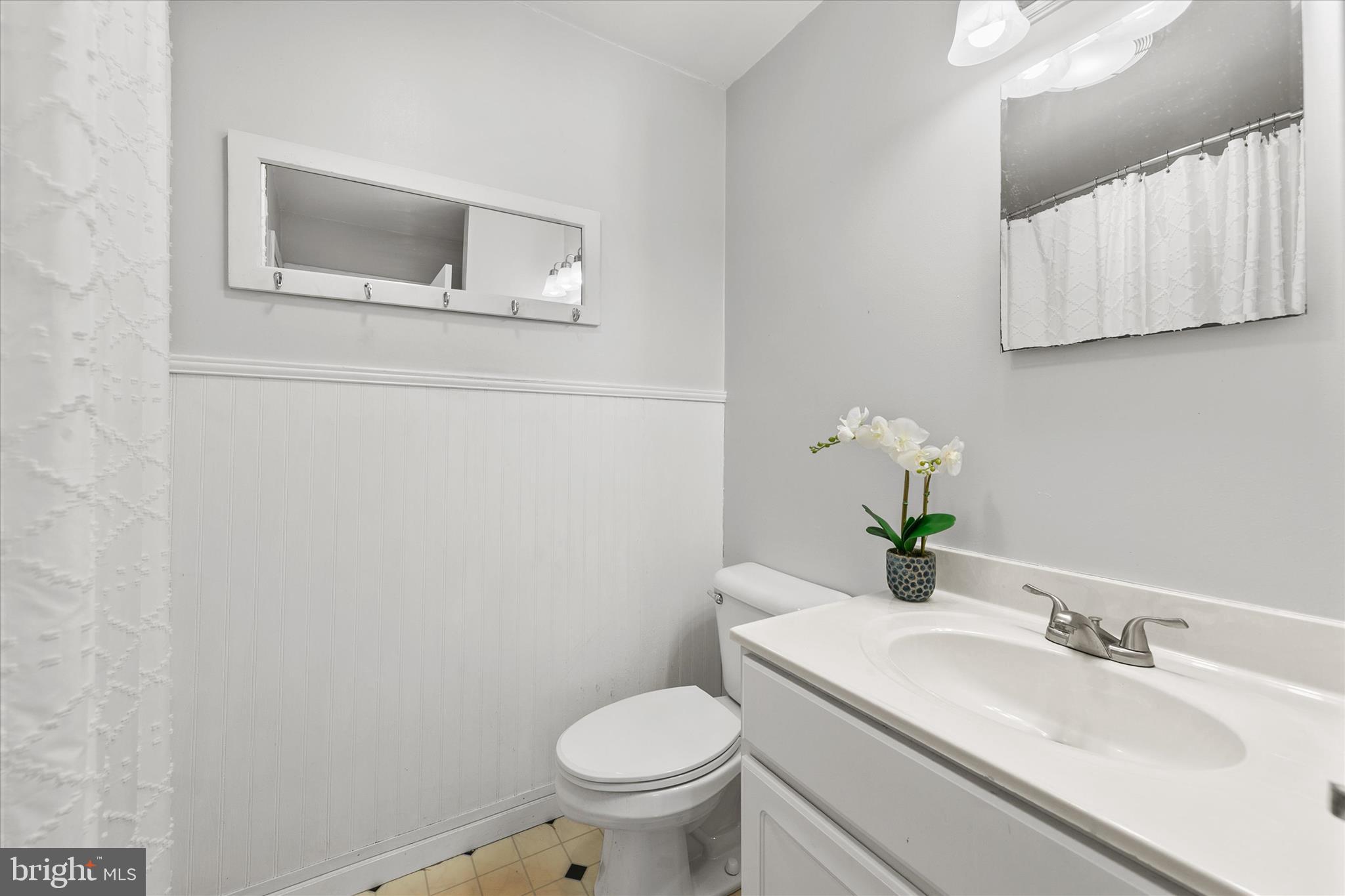 24618 Peterkins Road Georgetown, DE 19947 - Photo 36 of 47 a bathroom with a granite countertop toilet sink and mirror