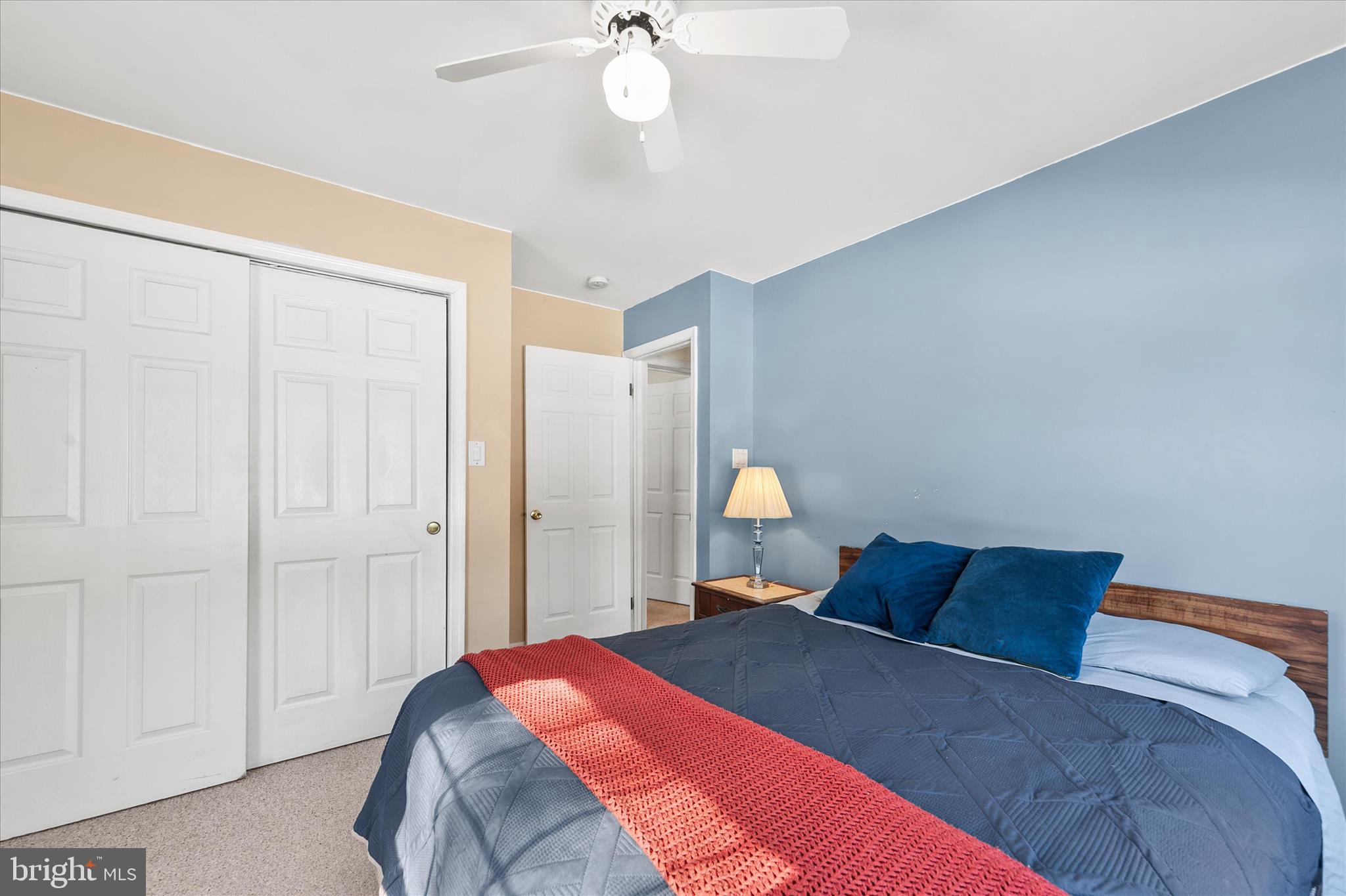 24618 Peterkins Road Georgetown, DE 19947 - Photo 38 of 47 a bedroom with a large bed and a chandelier