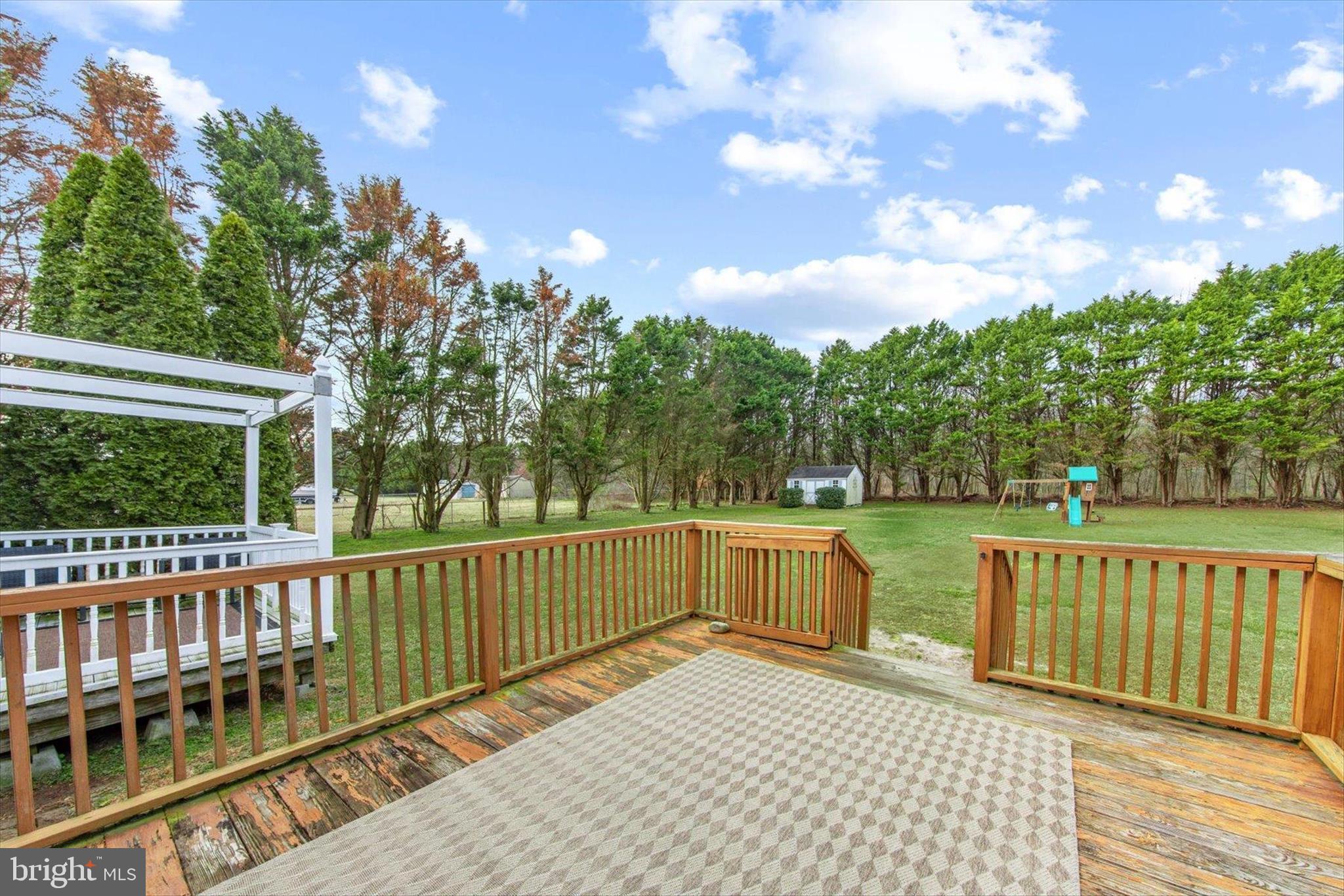 24618 Peterkins Road Georgetown, DE 19947 - Photo 41 of 47 a view of a porch with wooden floor and fence