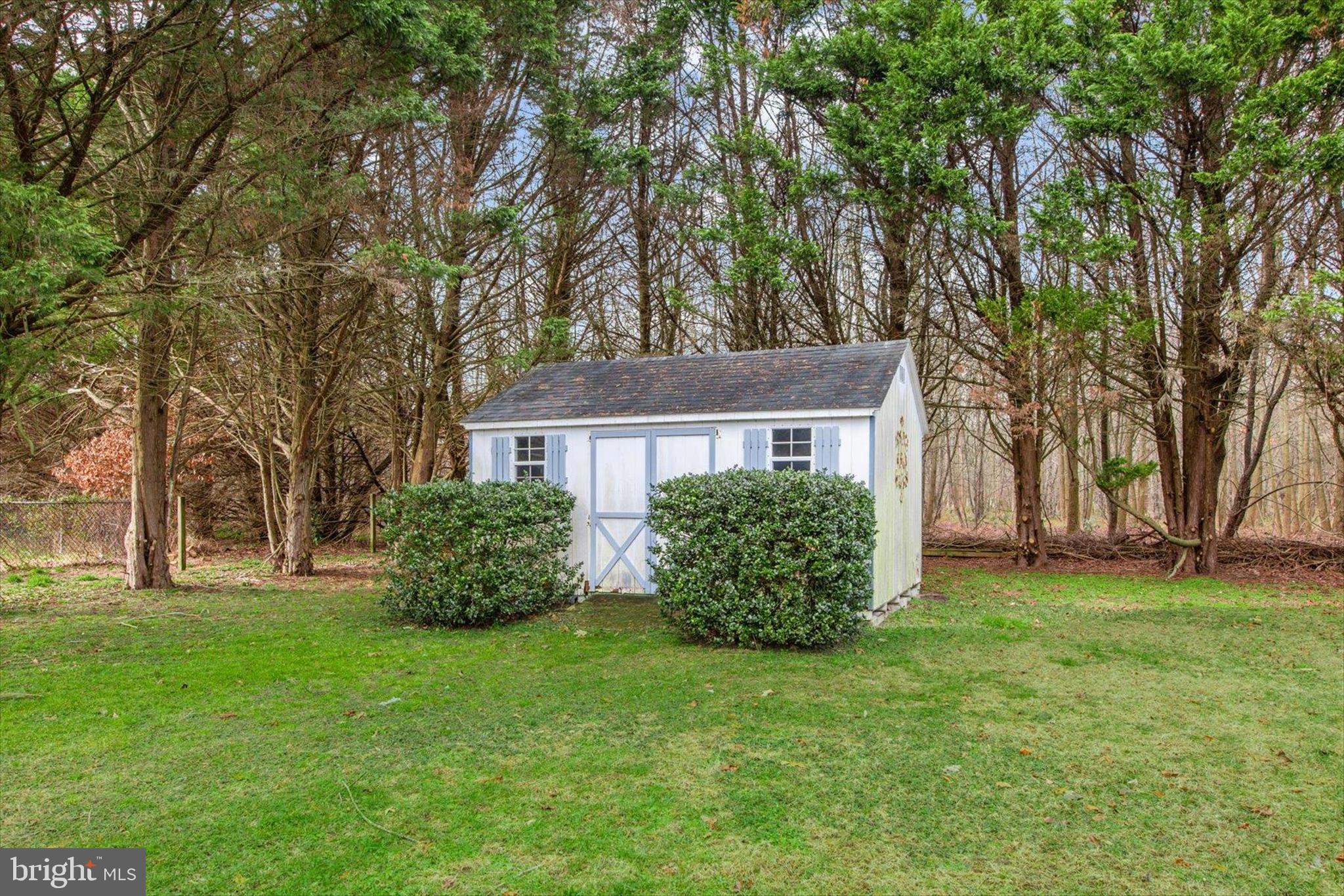 24618 Peterkins Road Georgetown, DE 19947 - Photo 44 of 47 a front view of house with yard and trees