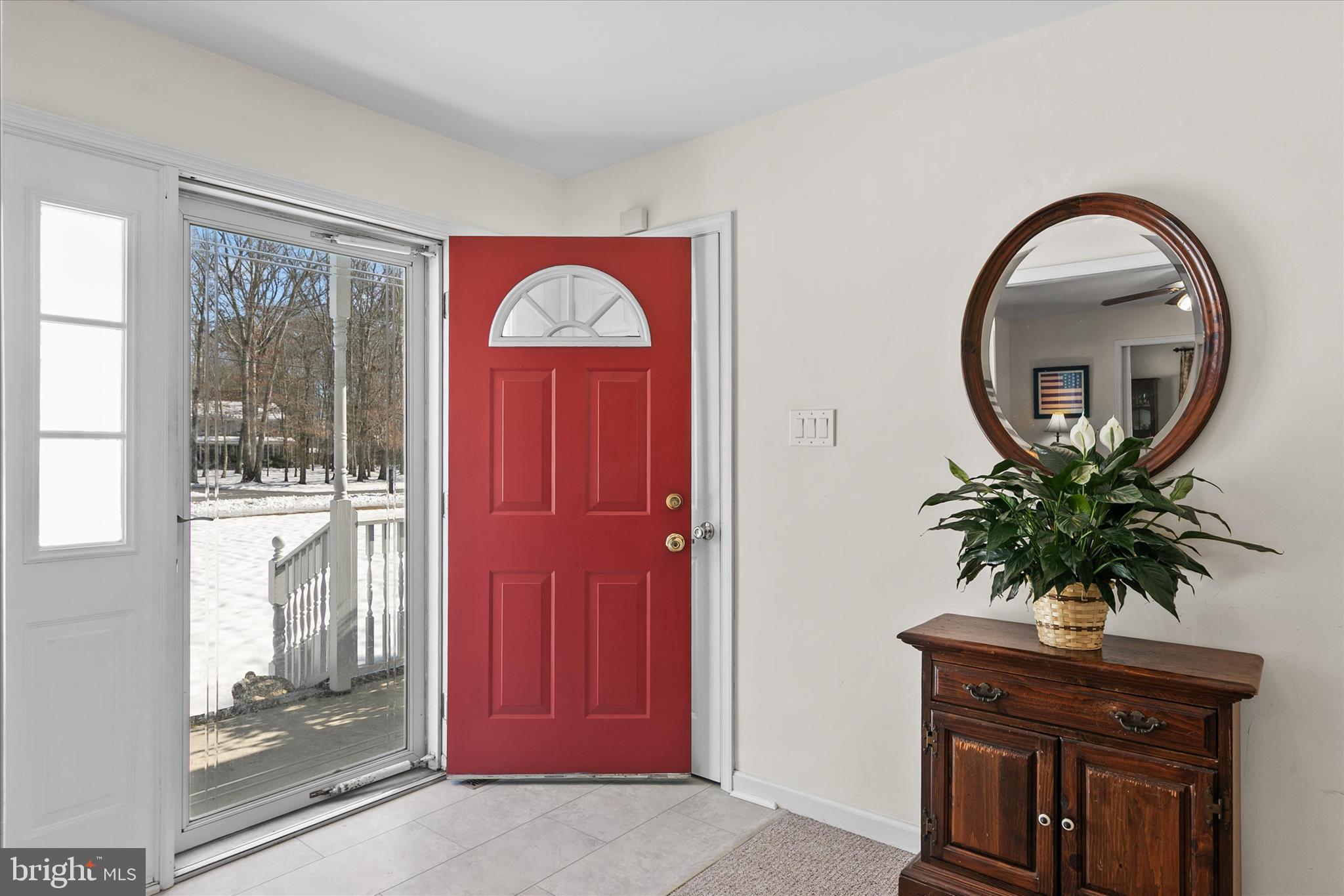 24618 Peterkins Road Georgetown, DE 19947 - Photo 8 of 47 a view of a entryway door with a potted plant in front of a door