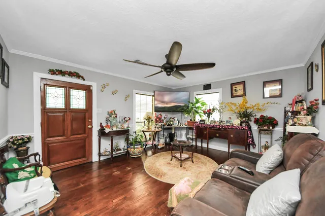 a living room with furniture and a wooden floor