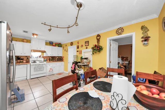 a living room with stainless steel appliances kitchen island granite countertop furniture and a view of kitchen