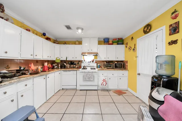 a kitchen with cabinets and appliances