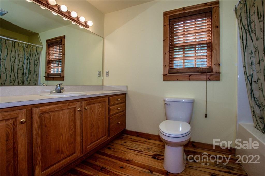 133 Folkstone Road, Unit 2 Mooresville, NC 28117 - Photo 20 of 32 a bathroom with a toilet sink and mirror