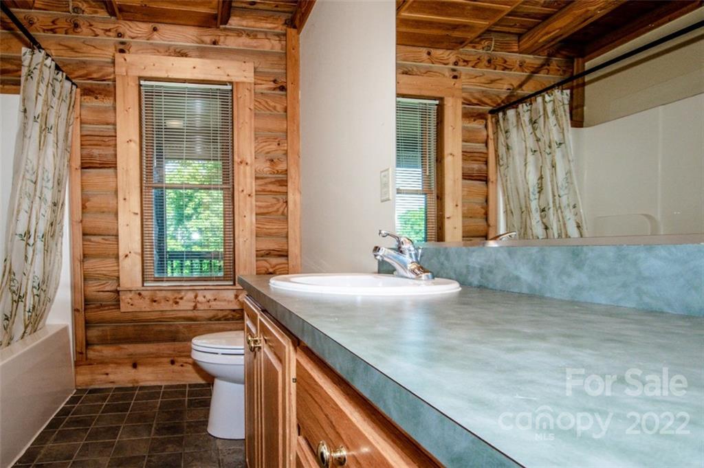 133 Folkstone Road, Unit 2 Mooresville, NC 28117 - Photo 22 of 32 a bathroom with a granite countertop sink and a mirror