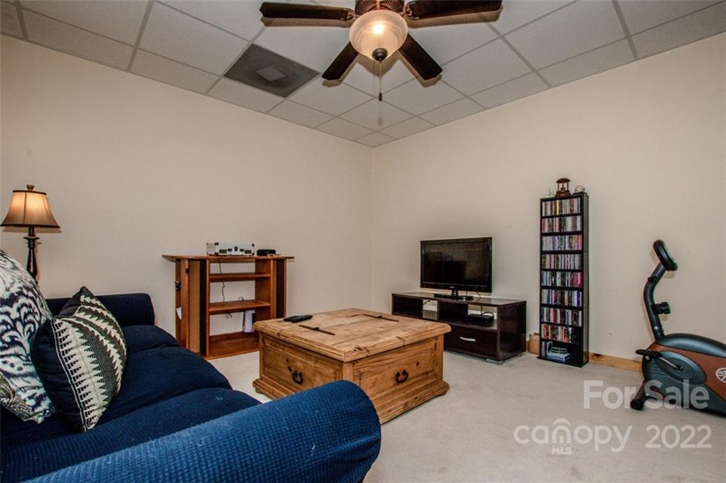 133 Folkstone Road, Unit 2 Mooresville, NC 28117 - Photo 24 of 32 a living room with furniture and a flat screen tv