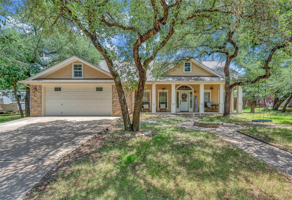 37 Bluebonnet Loop Morgan's Point Resort, TX 76513 - Photo 1 of 38 Single-story residence featuring a covered front porch with white columns, a two-car garage, and a concrete driveway