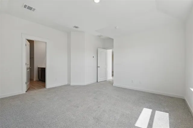 a view of empty room with wooden floor and ceiling fan
