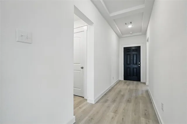 a view of hallway with wooden floor