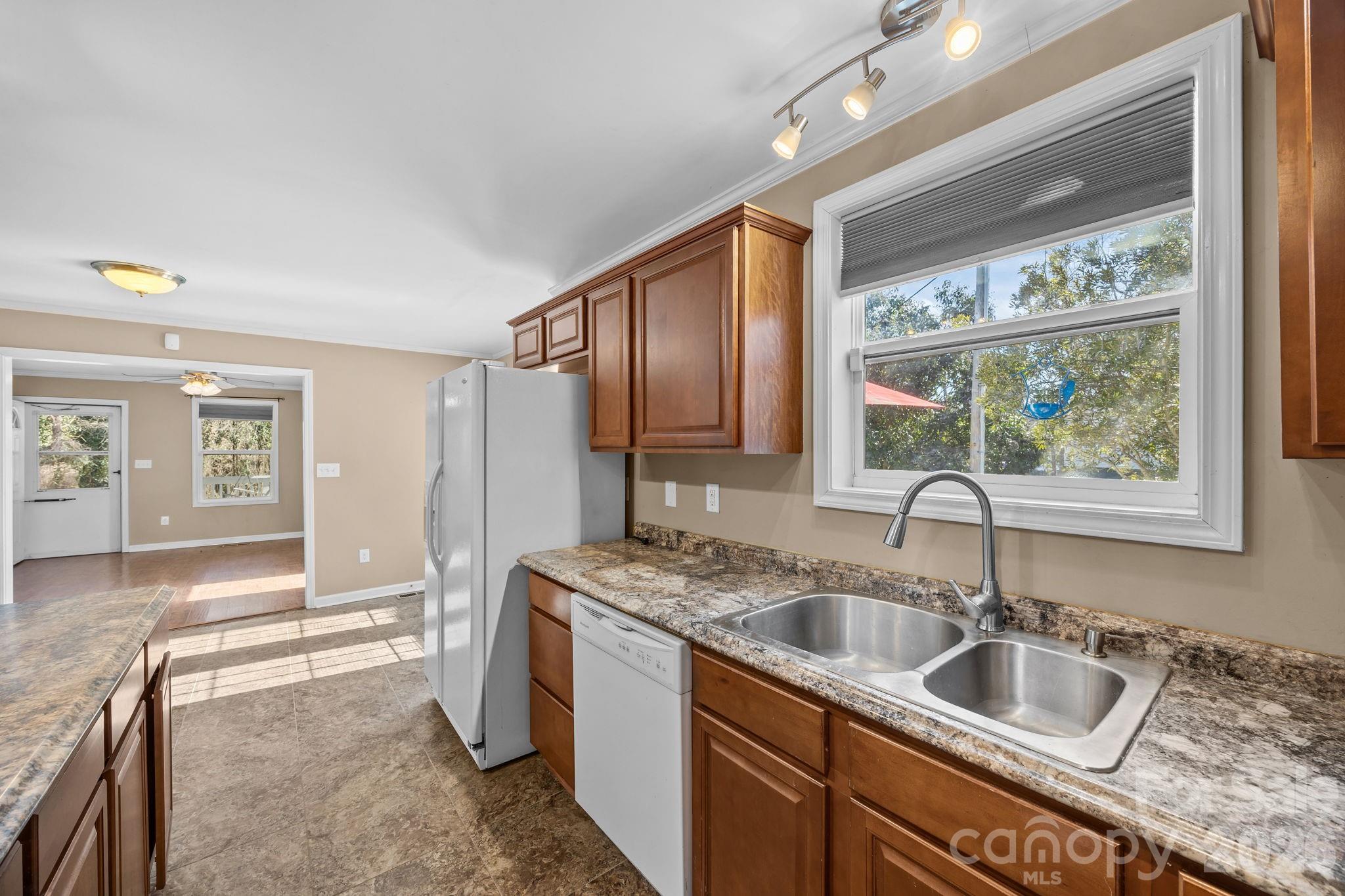 708 Old Charlotte Road Southwest Concord, NC 28027 - Photo 18 of 35 a kitchen with a sink and a refrigerator