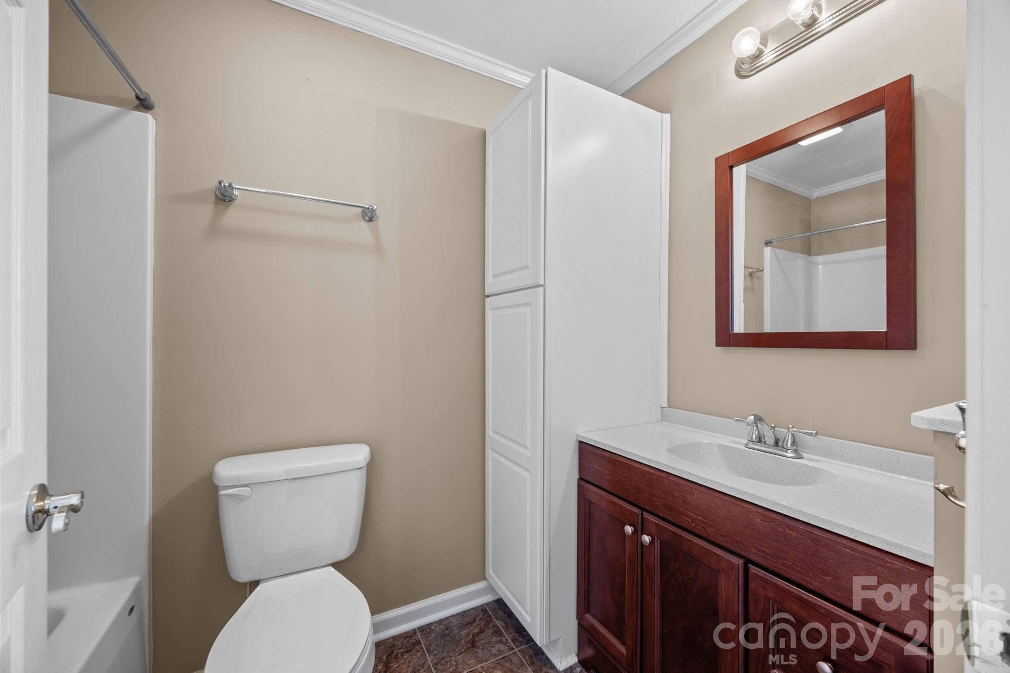 708 Old Charlotte Road Southwest Concord, NC 28027 - Photo 23 of 35 a bathroom with a toilet sink and mirror