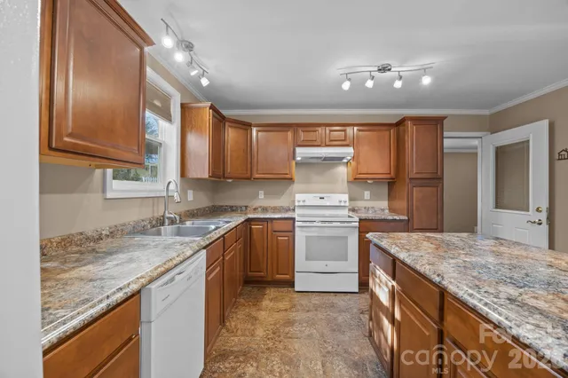 a kitchen with a sink stove and refrigerator