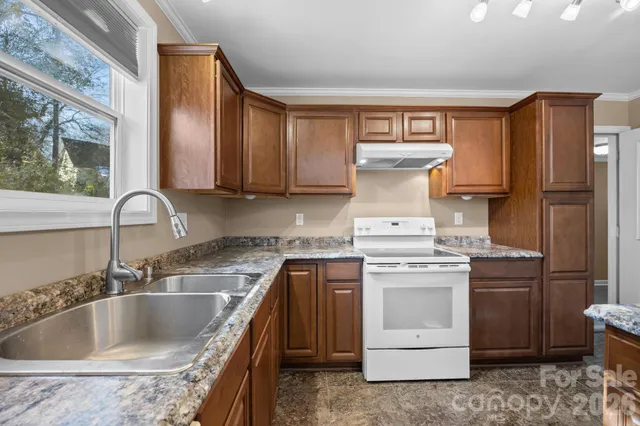 a kitchen with a stove sink and refrigerator