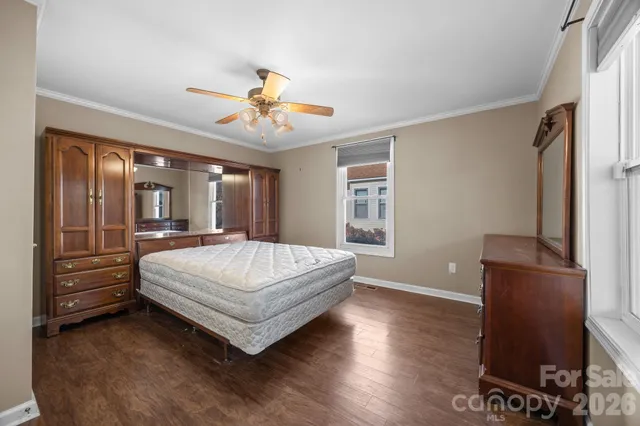 a spacious bedroom with a bed and a chandelier