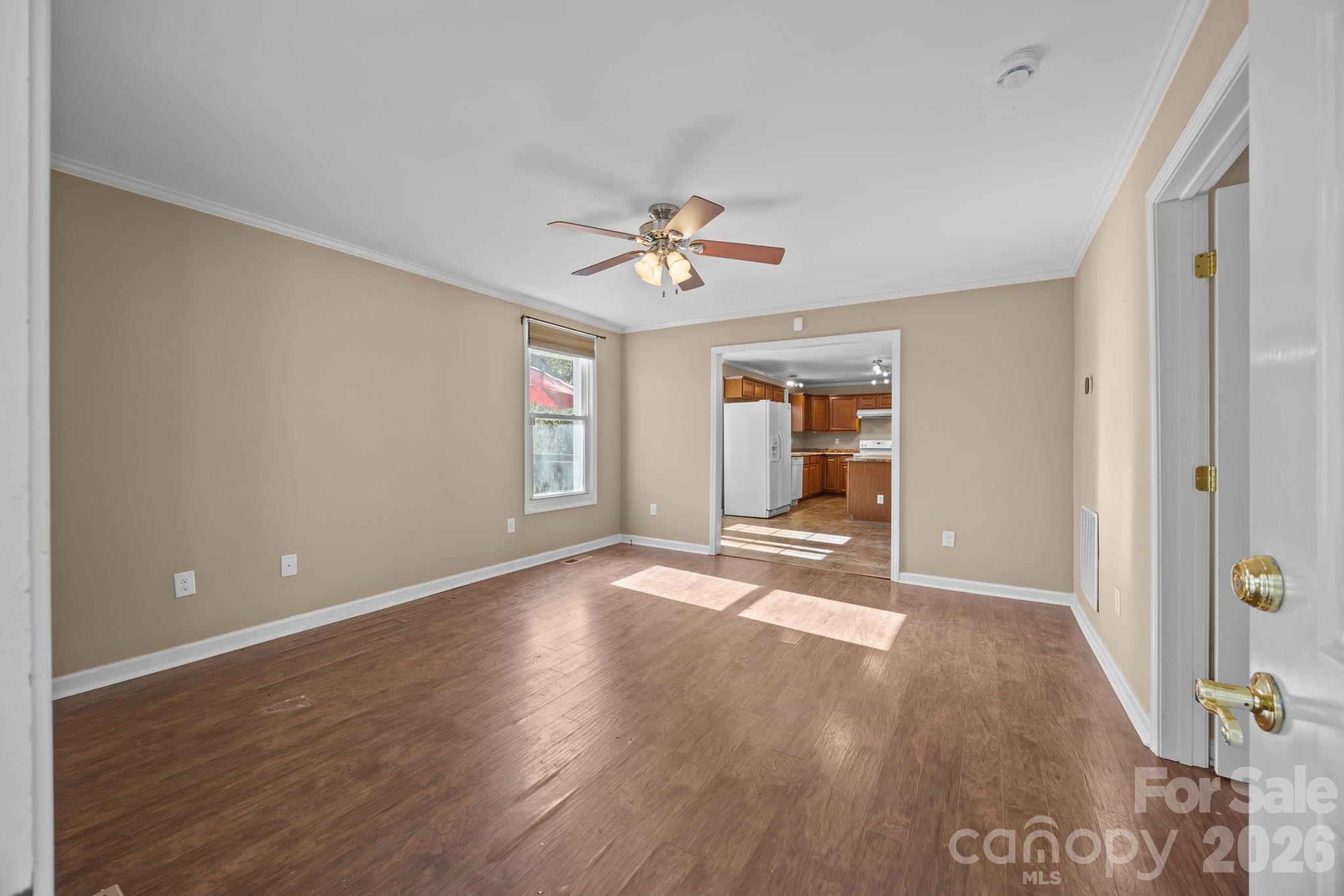 708 Old Charlotte Road Southwest Concord, NC 28027 - Photo 8 of 35 wooden floor in an empty room with a window