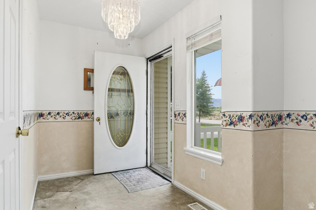 435 East 4th North Preston, ID 83263 - Photo 3 of 26 Entryway featuring a decorative oval-light front door, an overhead chandelier, and a side window