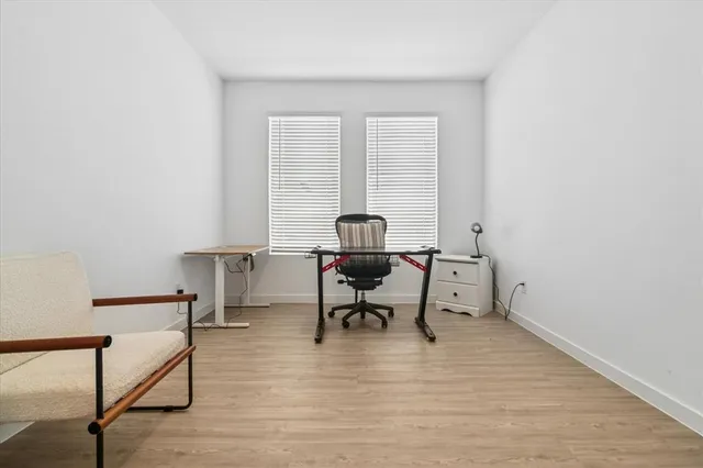 a view of a workspace with furniture and a window
