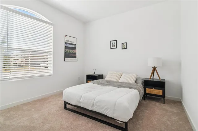 a living room with furniture and a mirror